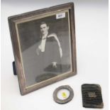 Two silver-mounted photograph frames; and a card case.
