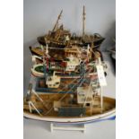 Five scale model wooden trawlers.