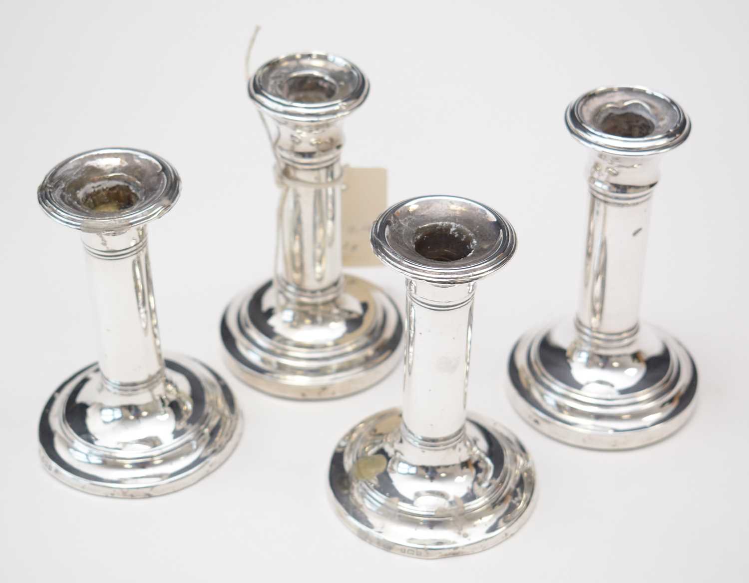 Set of four silver candlesticks.