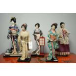 Five costume dolls.