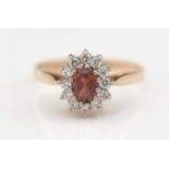 A diamond and garnet cluster ring.