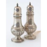 Pair of American silver pepperettes.