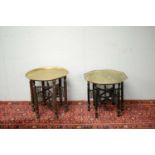 A pair of Islamic brass topped side tables.