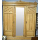 Late 19th C blond oak three-door wardrobe.