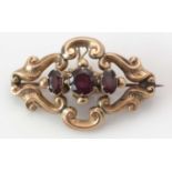 A garnet and yellow metal Victorian brooch.