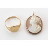 18ct. yellow gold signet ring; and a carved shell Cameo.