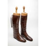 Pair of early 20th C brown leather riding boots and trees.