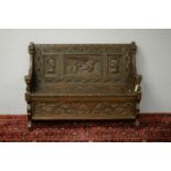 Early 20th C carved oak settle.