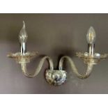 A selection of moulded glass and chrome wall lights, each fitting holding three branches.