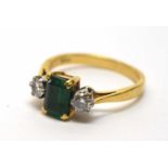 An emerald and diamond ring