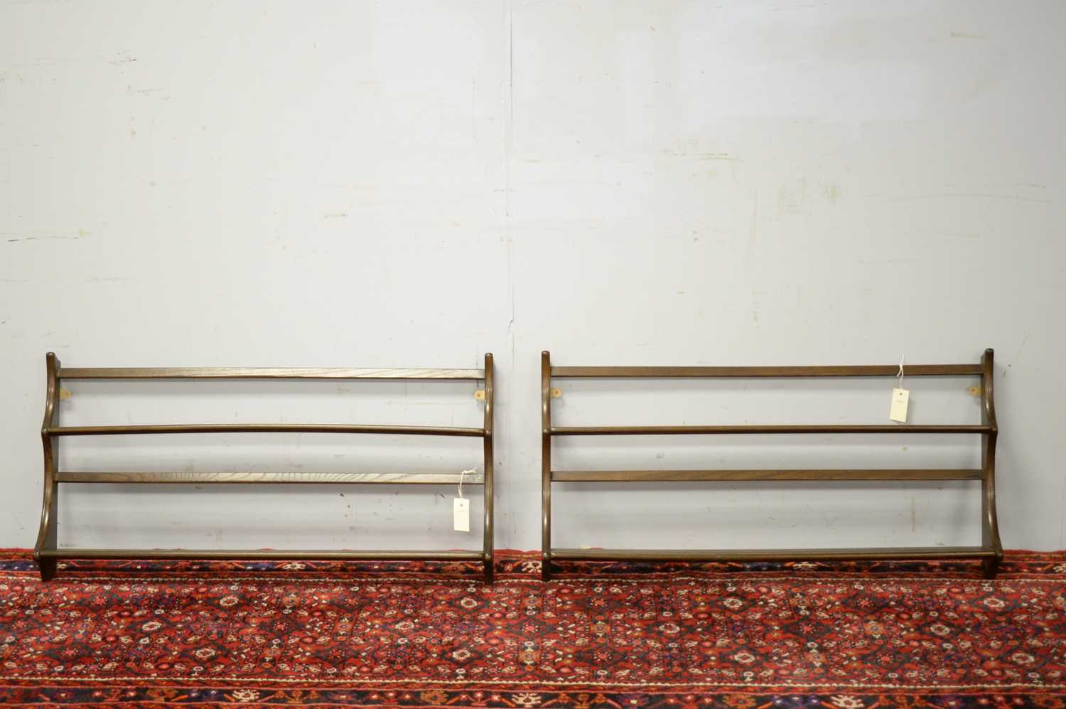 Pair of 20th C Ercol elm hanging shelves.