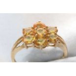 A yellow sapphire cluster ring.