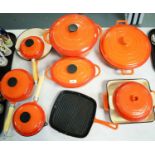 Cooks Professional cast iron cooking set, comprising: a selection of pots and pans, with covers; two