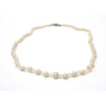 A white opal bead and crystal necklace.