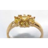 A seven-stone yellow sapphire cluster ring.