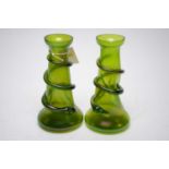 A pair of iridescent green glass vases.
