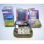 A Nintendo Game Boy along with a collection of Game Boy games and others.