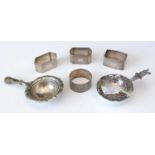 Two Continental silver tea strainers; and four silver napkin rings.