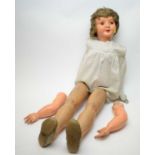 An early 20th Century wood and papier mache child doll