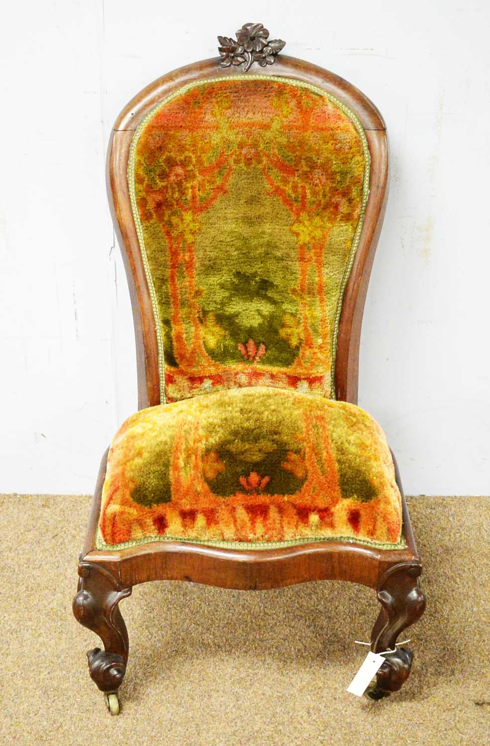 A Victorian rosewood nursing chair.