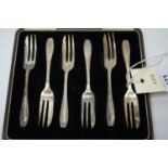 A set of six silver cake forks