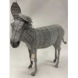 Beaded silvered model of a donkey.