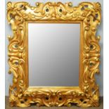 An 18th Century style gold painted wall mirror