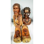 Two African carved wood busts and two others.