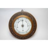 An early 20th century oak barometer.