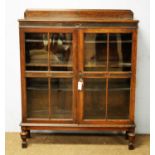 An early 20th Century oak display cabinet