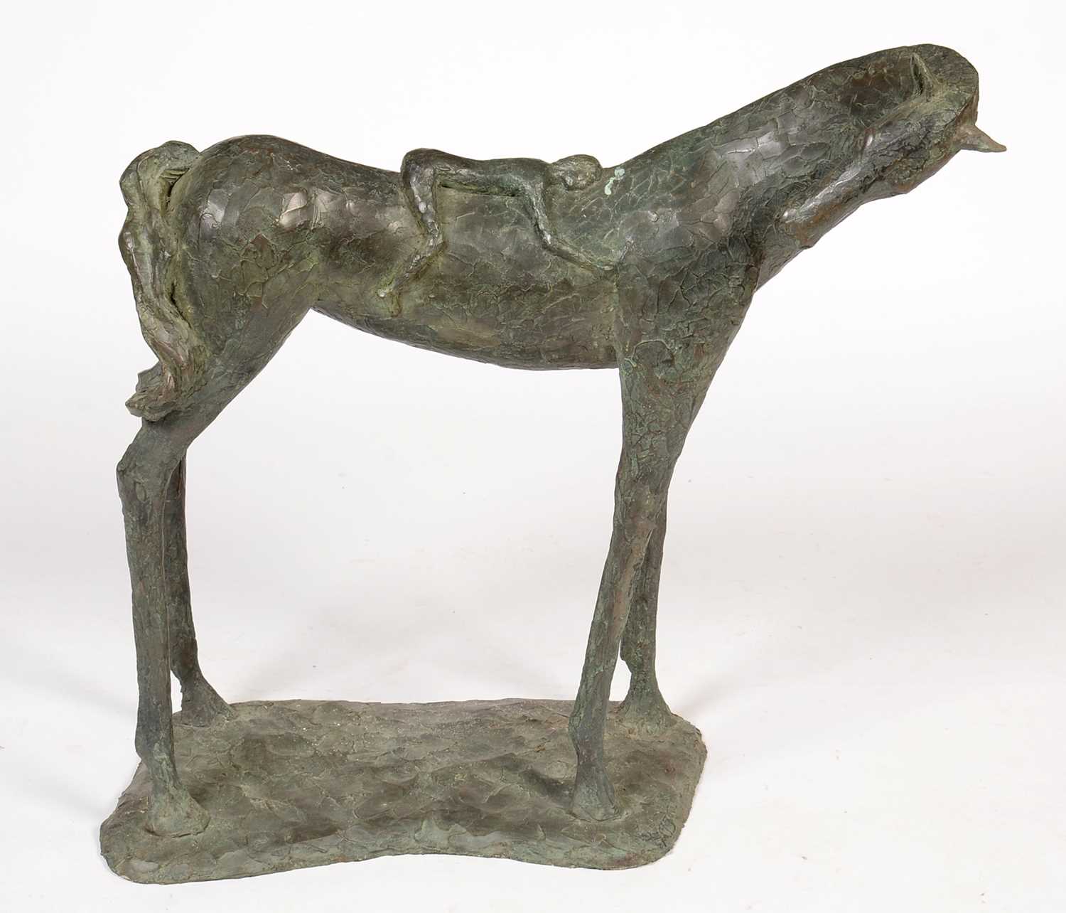A contemporary resin model of a small figure resting on a horse