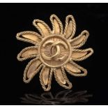 Chanel: gilt metal sun brooch