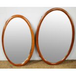 Pair of Edwardian mahogany oval wall mirrors.