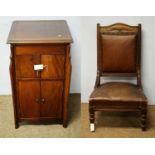 An early 20th Century mahogany cupboard / A late Victorian beech easy armchair