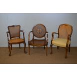 Three 20th C bergere armchairs.