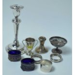 A George V silver candlestick and other small silver items.