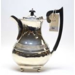 A George V silver coffee pot.
