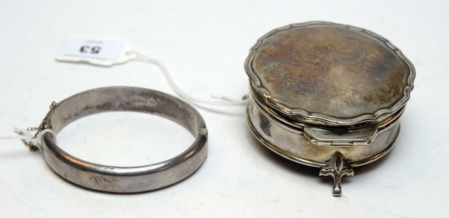 An antique silver ring box.