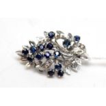 A high-carat white metal sapphire brooch.