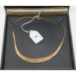 A 9ct gold tri-coloured collar necklace.