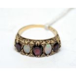 A yellow metal, opal and garnet dress ring,