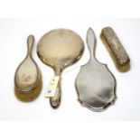 Antique silver hand mirrors, hair, and clothes brushes.