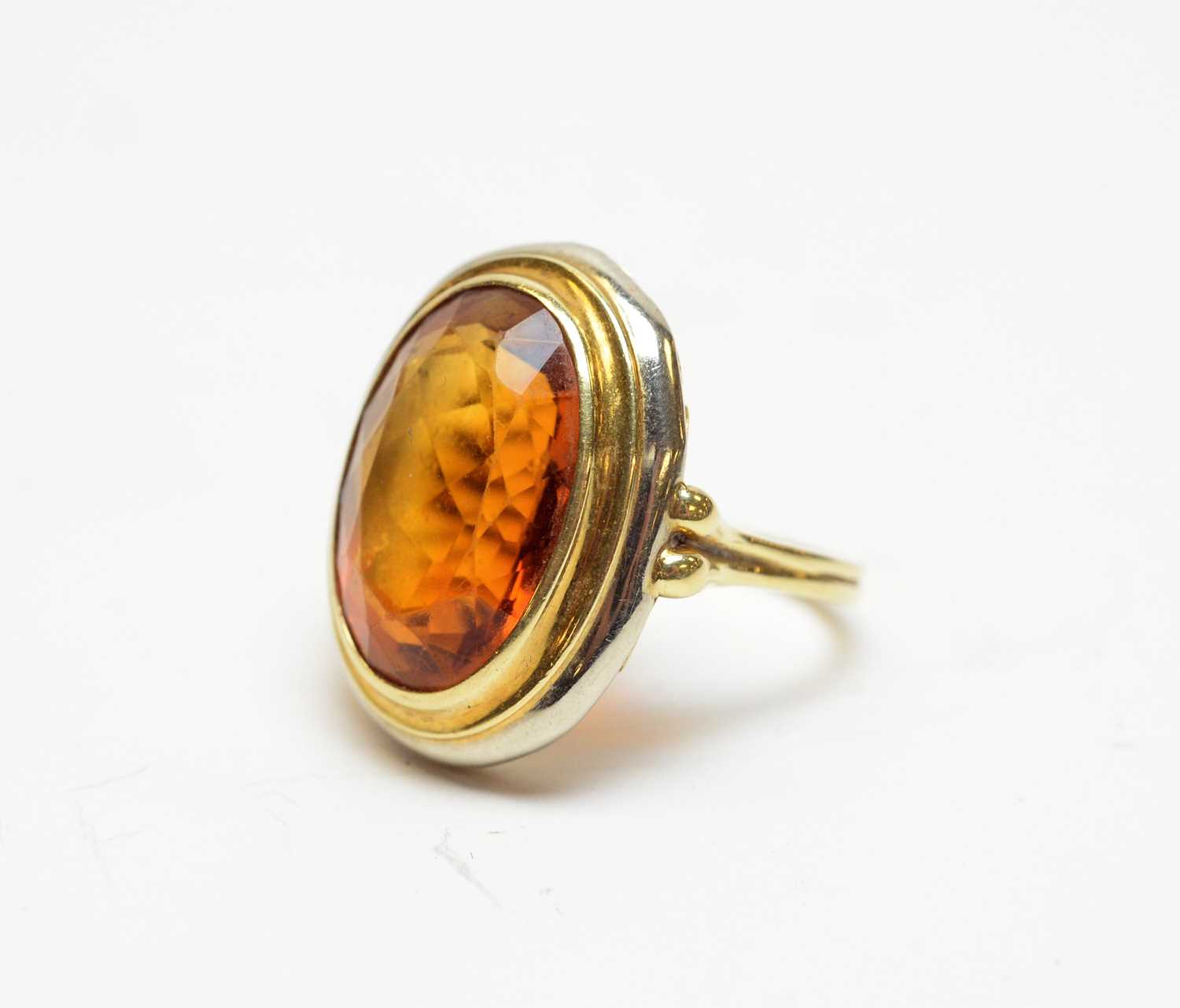 A citrine and high-carat white and yellow metal cocktail ring.