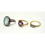 Three vintage rings, including a three-stone diamond ring.