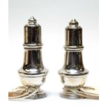 A pair of Elizabeth II silver salt and pepper pots.