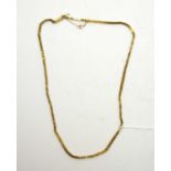A yellow metal rope-link neck chain.