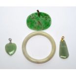 Four items of jade jewellery.