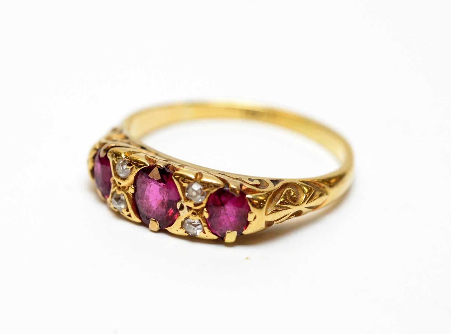 A three-stone ruby and diamond dress ring.