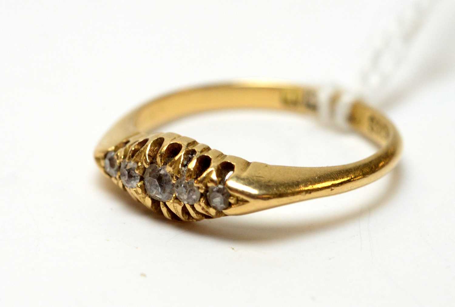 An antique 18ct gold and five stone diamond ring.