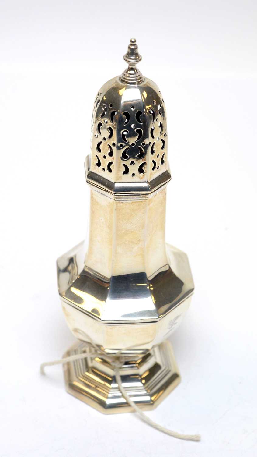 A George V silver sugar caster retailed by Harrods.